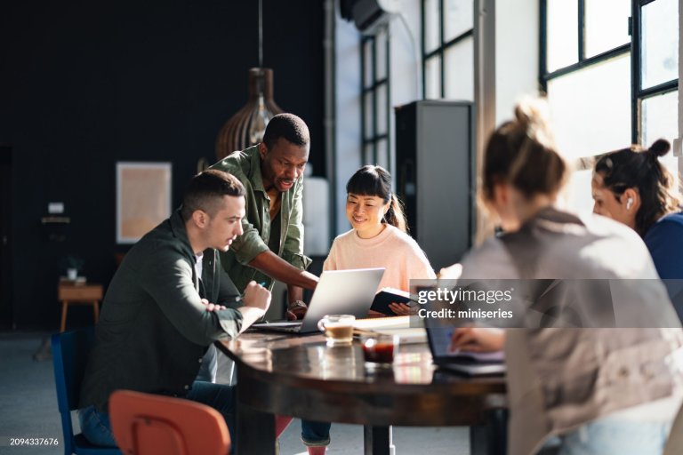 Young professionals or students collaborating in a bright, contemporary co-working environment, displaying teamwork and productivity.