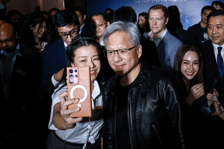 Jensen Huang, co-founder and chief executive officer of Nvidia Corp., center right, poses for a selfie photograph with an attendee during the Siam AI Co. AI Vision for Thailand event in Bangkok, Thailand, on Wednesday, Dec. 4, 2024. Thailand's government and chip-maker Nvidia agreed to strengthen cooperation in artificial intelligence, as the Southeast Asian nation seeks to become a regional hub for AI and data centers. Photo: Bloomberg via Getty Images