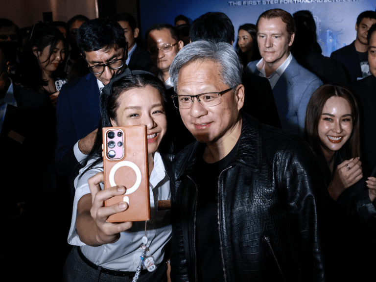 Jensen Huang, co-founder and chief executive officer of Nvidia Corp., center right, poses for a selfie photograph with an attendee during the Siam AI Co. AI Vision for Thailand event in Bangkok, Thailand, on Wednesday, Dec. 4, 2024. Thailand's government and chip-maker Nvidia agreed to strengthen cooperation in artificial intelligence, as the Southeast Asian nation seeks to become a regional hub for AI and data centers. Photo: Bloomberg via Getty Images