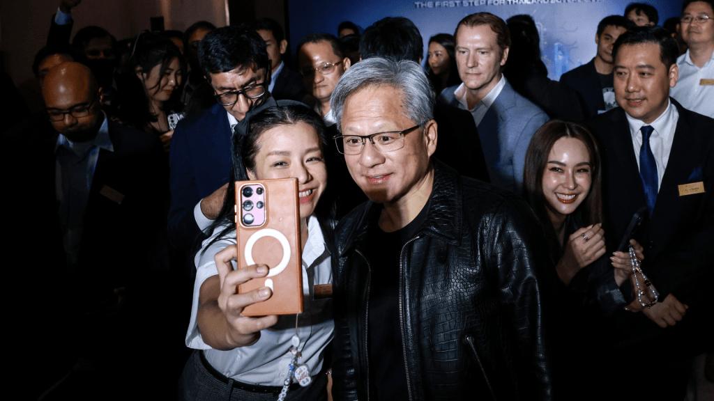 Jensen Huang, co-founder and chief executive officer of Nvidia Corp., center right, poses for a selfie photograph with an attendee during the Siam AI Co. AI Vision for Thailand event in Bangkok, Thailand, on Wednesday, Dec. 4, 2024. Thailand's government and chip-maker Nvidia agreed to strengthen cooperation in artificial intelligence, as the Southeast Asian nation seeks to become a regional hub for AI and data centers. Photo: Bloomberg via Getty Images