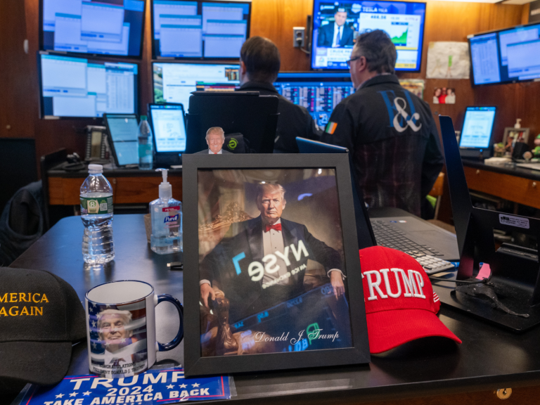 A picture of Donald Trump is displayed as traders work on the New York Stock Exchange floor. (Photo: Getty Images.)