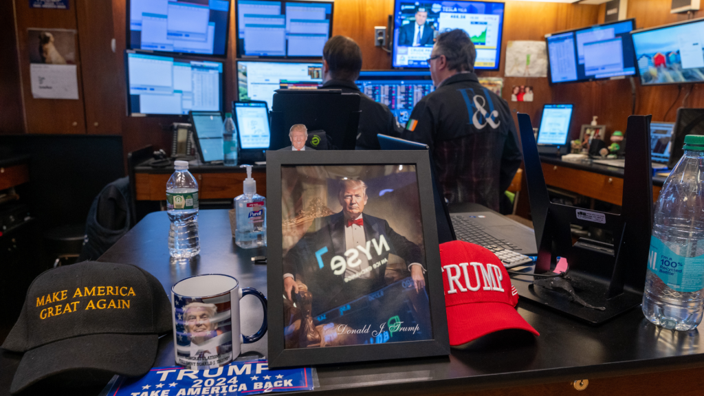 A picture of Donald Trump is displayed as traders work on the New York Stock Exchange floor. (Photo: Getty Images.)