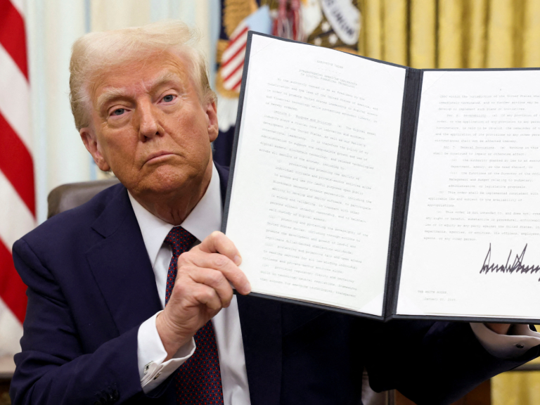 US President Donald Trump holds a signed executive order on cryptocurrencies. Photo: Reuters