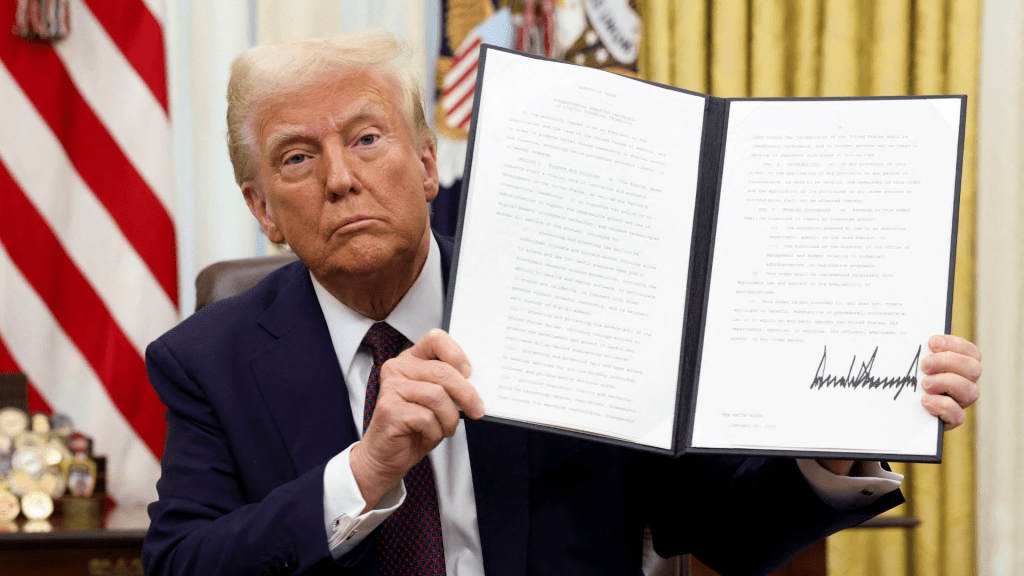 US President Donald Trump holds a signed executive order on cryptocurrencies. Photo: Reuters