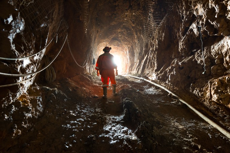 A miner inside the access tunnel of an underground gold and copper mine in Chile.