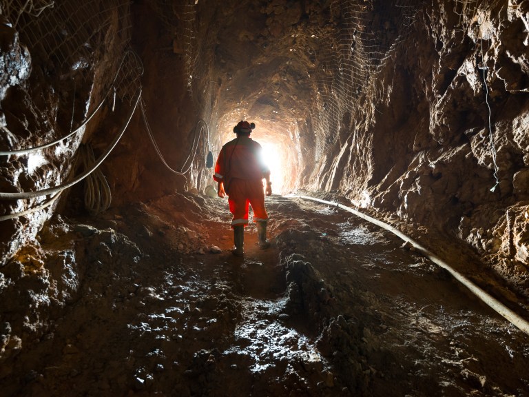 A miner inside the access tunnel of an underground gold and copper mine in Chile.