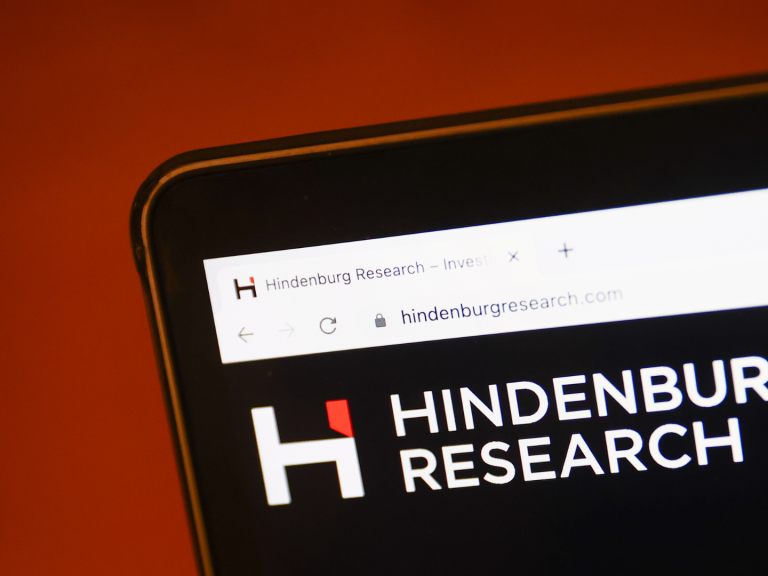 Hindenburg Research website displayed on a laptop screen and Adani logo displayed on a phone screen are seen in this illustration photo taken in Krakow, Poland on February 2, 2023