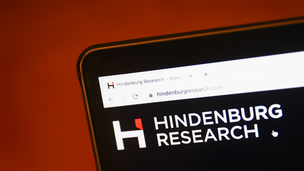 Hindenburg Research website displayed on a laptop screen and Adani logo displayed on a phone screen are seen in this illustration photo taken in Krakow, Poland on February 2, 2023