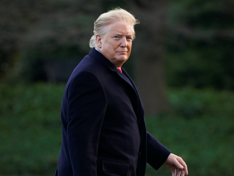 Donald Trump walks to the Oval Office.